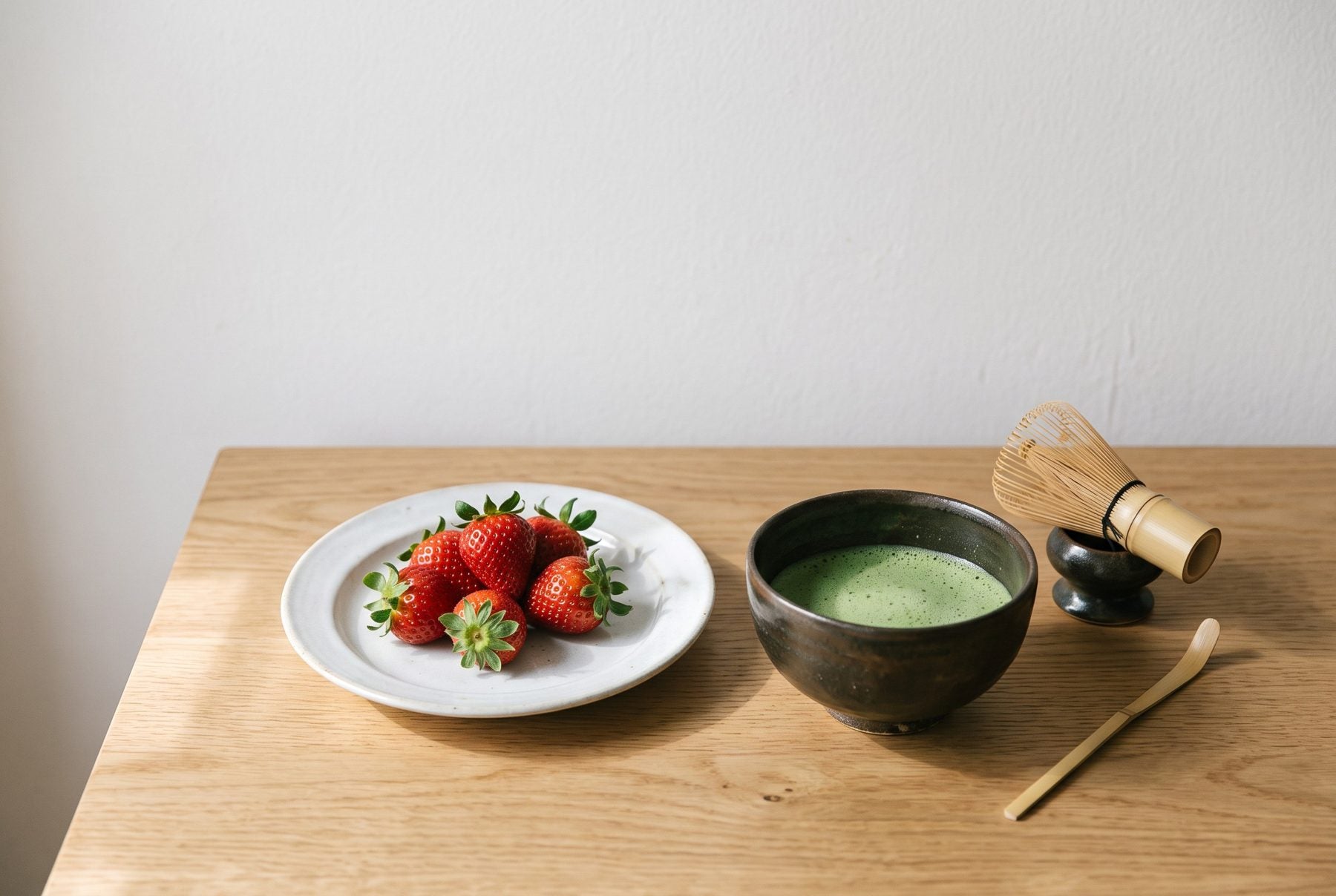 白い器に盛ったイチゴと、点てたばかりの抹茶の茶碗が並んだ食卓